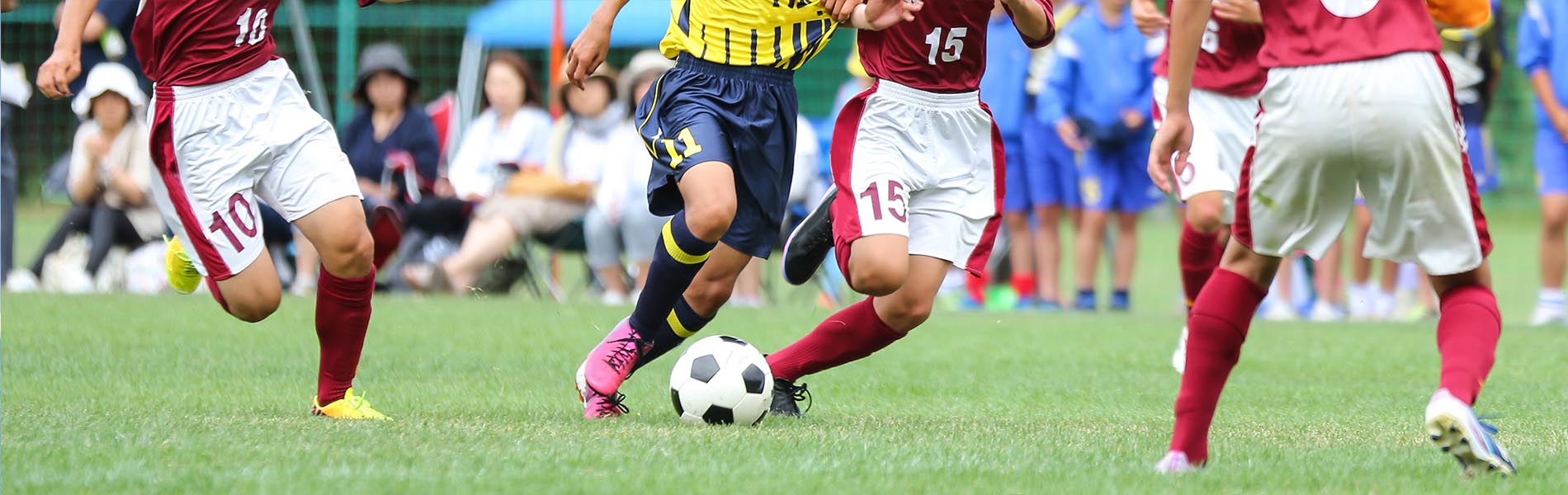 The image shows a soccer match with two teams playing on a field one team s jerseys are blue, and the other team s jerseys are red.